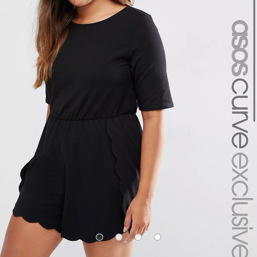 Black romper with scalloped detail on the bottom